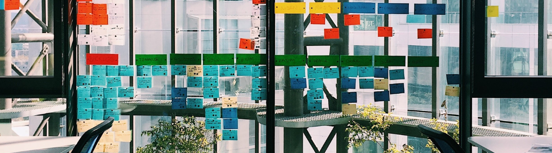 A window in an office covered in sticky notes 